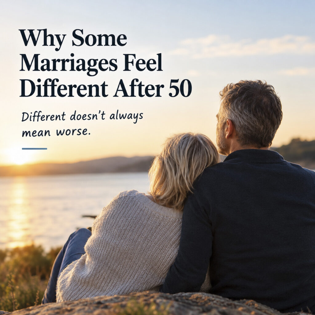 Mature couple sitting together on a rocky cliff watching the sunset over water with text reading "Why Some Marriages Feel Different After 50."